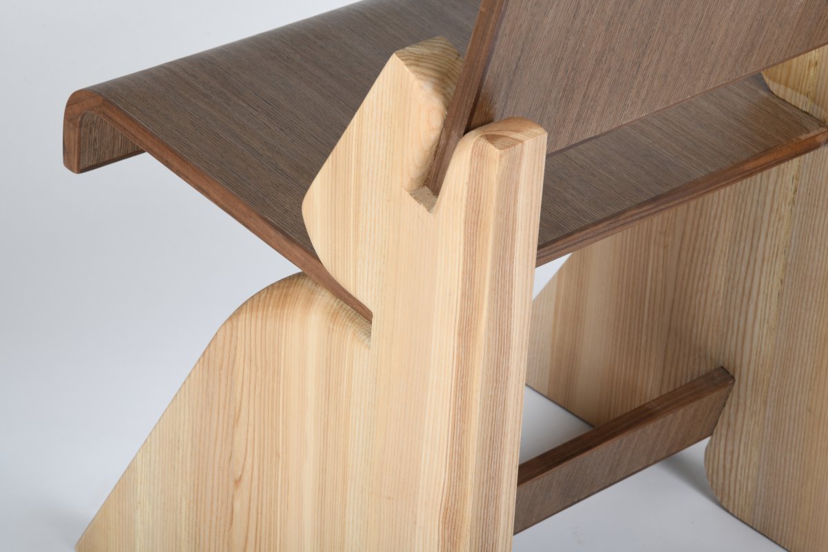 This chair explores the relationship between mass and tension through its construction and form. The base is crafted from solid wood, with precise slits cut to allow the seat and backrest to be seamlessly inserted. The seat and back are made from pressed bendy plywood finished with a walnut veneer, contrasting the solidity of the structure with a lighter, more fluid surface.  The concept behind the design is the idea of a heavy, grounded form being pierced by something thin, generating tension and resulting in curves. This dialogue between solidity and delicacy informs both the structural logic and the visual language of the piece.  The chair was fully handcrafted by myself under the guidance of my professor, reflecting both technical skill and conceptual exploration.  Final product photo credits: Professor Ammar Kalo